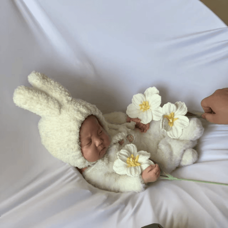 baby holding flowers